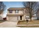 Two-story house with beige siding, attached garage, and landscaping at 3721 Rinehall Dr, Indianapolis, IN 46235