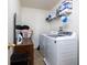 Bright laundry room with washer, dryer, and shelving at 3721 Rinehall Dr, Indianapolis, IN 46235