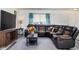 Living room with sectional sofa and large TV at 3721 Rinehall Dr, Indianapolis, IN 46235