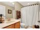 Well-lit bathroom featuring a vanity with a sink, toilet, and shower with a curtain at 4343 Raintree Blvd, Greenwood, IN 46143