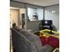 Living room with gray couch, yellow coffee table, and partial kitchen view at 4715 E 33Rd St, Indianapolis, IN 46218