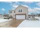 Two-story house with a brick and beige siding exterior, attached garage, and snow covered landscaping at 507 Abbywood Cir, Danville, IN 46122