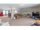 Open living room with sectional sofa, and a view into the dining area at 507 Abbywood Cir, Danville, IN 46122