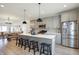 Modern kitchen with island, stainless steel appliances, and gray cabinets at 518 N Beville Ave, Indianapolis, IN 46201