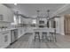 Modern white kitchen with island, stainless steel appliances, and quartz countertops at 552 W King St, Franklin, IN 46131