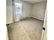 Spacious carpeted bedroom with large window and neutral walls at 5617 Yucatan Dr, Indianapolis, IN 46237