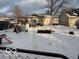 Large backyard with snow, playset, and detached structure at 602 Waldemere Ave, Indianapolis, IN 46241