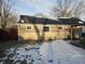 Backyard with a mix of brick and painted siding and a blanket of snow on the ground at 604 Gooseberry Ln, Greenwood, IN 46143