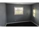 Bedroom with gray walls and a bright window overlooking the backyard at 604 Gooseberry Ln, Greenwood, IN 46143