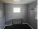 Bedroom with gray walls, hardwood floors, and bright window with natural light at 604 Gooseberry Ln, Greenwood, IN 46143