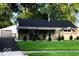 Charming single story home with a well-manicured front yard, large trees, and asphalt driveway at 604 Gooseberry Ln, Greenwood, IN 46143