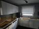 Kitchen under renovation featuring new white cabinets, countertops, and a window at 604 Gooseberry Ln, Greenwood, IN 46143