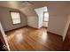 Bright bedroom featuring hardwood floors, a window, and neutral walls at 604 Walnut St, Anderson, IN 46012