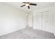 Simple bedroom with carpet flooring, ceiling fan and double closet with clean paint in a neutral color at 6327 E 52Nd Pl, Indianapolis, IN 46226