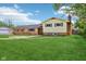 A two-story home boasts a combination of brick and vinyl siding, complemented by a well-maintained green lawn at 6327 E 52Nd Pl, Indianapolis, IN 46226