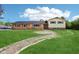 Inviting two-story home featuring a brick facade, manicured lawn, and charming brick walkway at 6327 E 52Nd Pl, Indianapolis, IN 46226