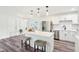 Bright, modern kitchen with stainless steel appliances, white cabinetry, and a quartz countertop island with bar stool seating at 6327 E 52Nd Pl, Indianapolis, IN 46226