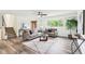 Living room showcasing neutral tones, updated floors, and large windows at 6327 E 52Nd Pl, Indianapolis, IN 46226
