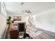 Open-concept living room with tan couches, modern light fixture, and stairway access at 6327 E 52Nd Pl, Indianapolis, IN 46226