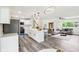 Open floor plan showcasing the living room and kitchen with modern decor and a staircase leading to the upper level at 6327 E 52Nd Pl, Indianapolis, IN 46226