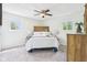 A serene main bedroom features a comfortable bed, ceiling fan, and natural light from two bright windows at 6327 E 52Nd Pl, Indianapolis, IN 46226
