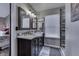 Modern bathroom with double vanity, large mirror, and a walk-in shower at 7257 Sycamore Run Dr, Indianapolis, IN 46237