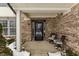 Front porch with brick columns and two chairs at 7257 Sycamore Run Dr, Indianapolis, IN 46237