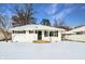 White ranch house with snow covered lawn at 7524 E 48Th St, Indianapolis, IN 46226