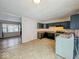 Kitchen with dark cabinets and view into adjacent living room at 7843 Huber Ct, Indianapolis, IN 46226