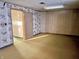 View of the basement with paneled walls, patterned wallpaper, and wall-to-wall carpet at 8104 Cheswick Dr, Indianapolis, IN 46219