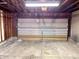 Garage featuring a paneled door and overhead lighting at 8104 Cheswick Dr, Indianapolis, IN 46219