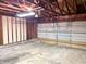 Large garage area with paneled door and a ceiling light at 8104 Cheswick Dr, Indianapolis, IN 46219