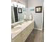 Double vanity bathroom with a gray wall and floor at 8309 W Ashford Ln, Muncie, IN 47304