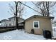 Backyard view with detached garage and snow-covered ground at 913 N Tremont St, Indianapolis, IN 46222