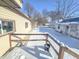 Snowy backyard with view from deck; mature trees and neighboring houses visible at 107 E Garfield St, Alexandria, IN 46001