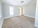 Bright bedroom with neutral carpet and access to hallway at 107 E Garfield St, Alexandria, IN 46001