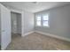 Spacious bedroom with neutral walls, carpeting, and large window at 107 E Garfield St, Alexandria, IN 46001