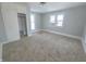 Well-lit bedroom with neutral carpeting and ample closet space at 107 E Garfield St, Alexandria, IN 46001