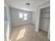 Well-lit bedroom with neutral carpet and closet space at 107 E Garfield St, Alexandria, IN 46001