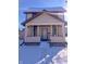Two-story house with covered porch, snow covered yard at 107 E Garfield St, Alexandria, IN 46001
