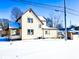 Two-story house with a snow covered backyard at 107 E Garfield St, Alexandria, IN 46001