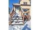 Snowy wooden steps leading to the house entrance at 107 E Garfield St, Alexandria, IN 46001