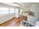 Bright kitchen featuring wood flooring, white cabinetry, and stainless steel appliances at 107 E Garfield St, Alexandria, IN 46001