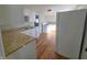 Small kitchen with white cabinets and wood floors at 107 E Garfield St, Alexandria, IN 46001