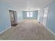 Bright living room offers neutral carpeting and an open floor plan at 107 E Garfield St, Alexandria, IN 46001