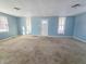 Spacious living room with light blue walls and neutral carpeting at 107 E Garfield St, Alexandria, IN 46001