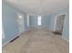 Spacious living area with light blue walls and neutral carpet at 107 E Garfield St, Alexandria, IN 46001