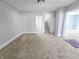 Living room with carpet flooring and access to staircase and other rooms at 107 E Garfield St, Alexandria, IN 46001