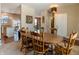 Dining room with wooden table and chairs, view of kitchen and entryway at 10968 Gossamer Ln, Noblesville, IN 46060