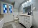 Bathroom with white vanity, stained glass windows, and a toilet at 1203 W 8Th St, Anderson, IN 46016